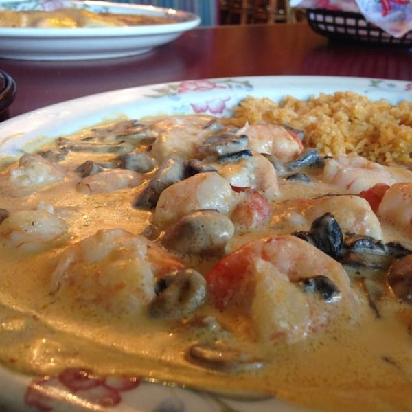 Jalisco's Mexican Restaurant's creamy shrimp and mushroom dish with a side of rice.